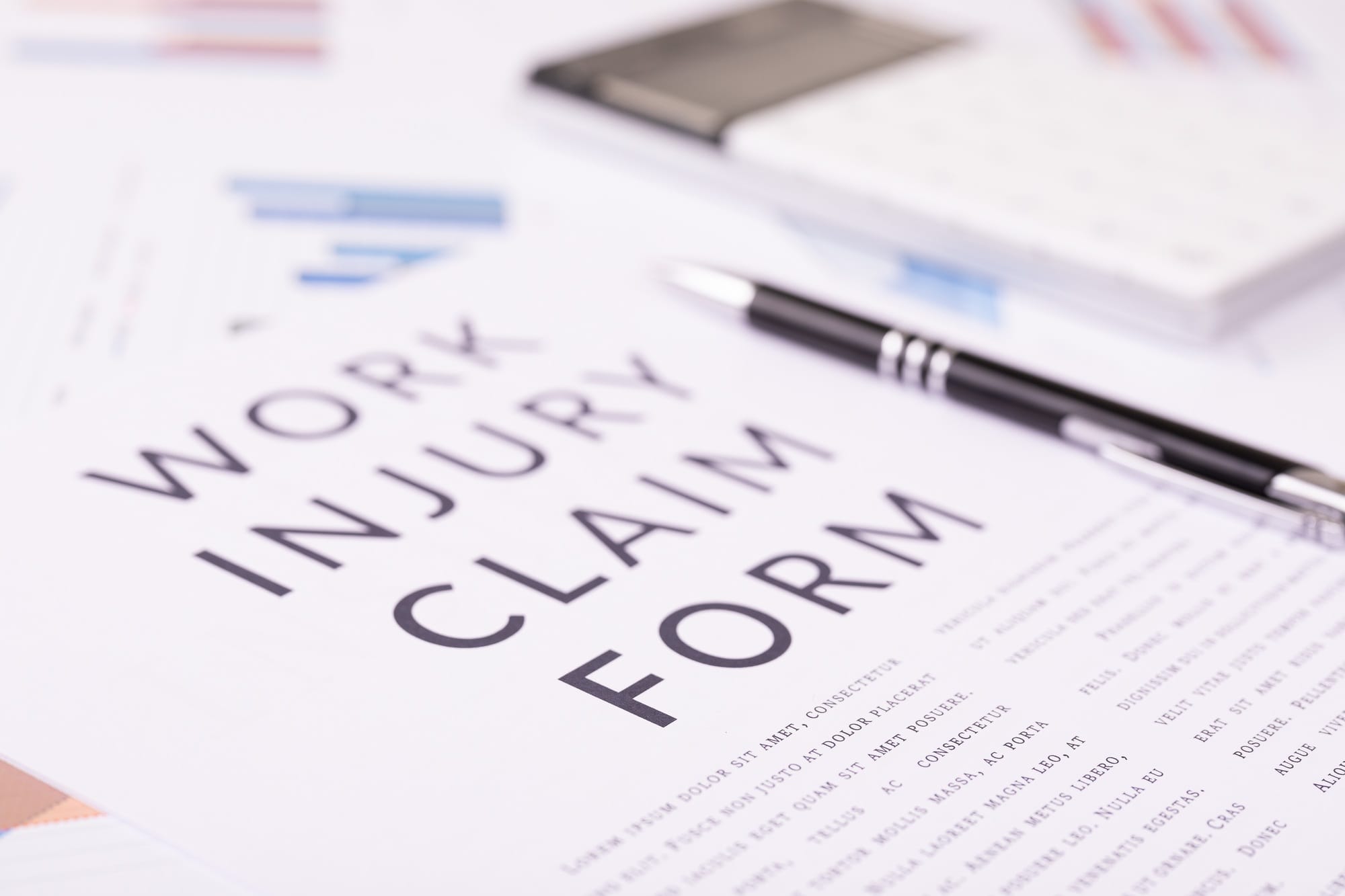 work injury claim form concept, documents on the desktop